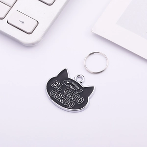 Minimalist cat head shaped pet tag with fish bone engraving and El Gato Gordo text