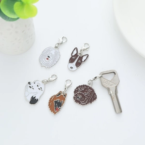 Detail of five enamel dog pendants with lobster clasps including Samoyed and Terrier