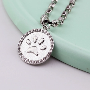 Silver crystal dog paw pendant necklace with sparkling rhinestones for pets and owners