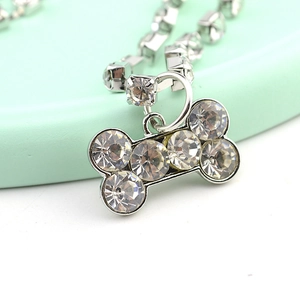 Close-up of a silver bone-shaped pet pendant necklace with sparkling crystal rhinestones