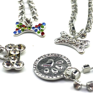 Sparkling crystal rhinestone bone pendants and paw tags on silver pet necklaces