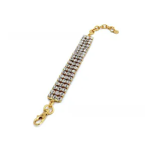 Detail of golden four-row rhinestone dog collar with adjustable chain and lobster clasp