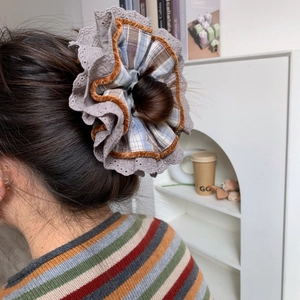 Brown velvet and plaid oversized layered scrunchie on model bun for autumn style