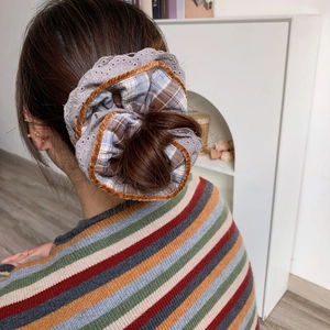 Brown plaid velvet and lace large scrunchie for women shown on hair in warm indoor setting