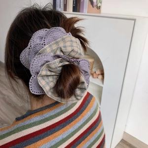 Detailed look at large purple crochet lace and plaid scrunchie styled on model hair