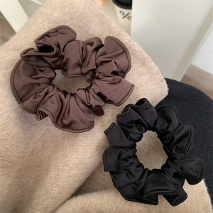 Satin silk hair scrunchies in black and dark brown with elegant pleated texture