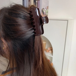 Deep chocolate brown acetate hair claw clip for thick hair shown in a lifestyle setting