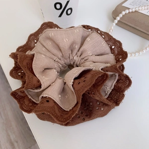 Detailed macro view of retro lace layered hair scrunchie in coffee and brown dots
