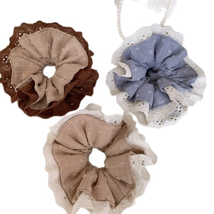 Three vintage lace scrunchies in brown, grey blue, and cream white with dot texture