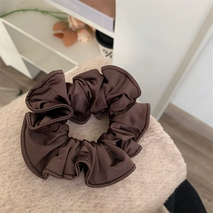 Minimalist dark brown satin scrunchie with textured fabric and elastic inner band
