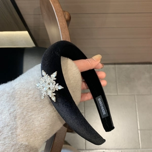 Elegant black velvet headband with a rotating sparkling crystal snowflake ornament for women