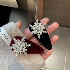 Detail view of velvet water drop clips with sparkling snowflake rhinestone accents