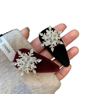 Velvet hair clips with rotating crystal snowflake design in burgundy and black finish