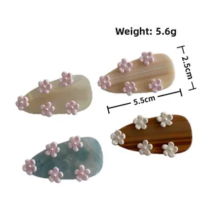 Detail view of 5.5cm acetate hair clips with 3D floral and pearl accents, weight 5.6g