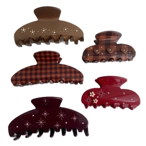 Set of five elegant star and plaid hair claw clips in deep red and brown tones