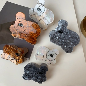 Cute koala acetate hair claws in various colors and sizes on minimalist background