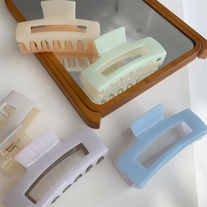 Detail view of large rectangular macaron hair claw clips with matte finish and metal spring