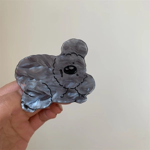 Detailed close-up of marble pattern acetate hair claw clip in a cute bear shape