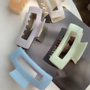 Macro view of matte square hair claw clips in assorted pastel macaron colors