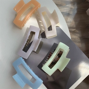 Set of 5 large matte rectangular hair claws in Morandi colors on a fashion magazine