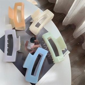 Macro view of rectangular macaron hair clips showing high-gloss acetate finish and details