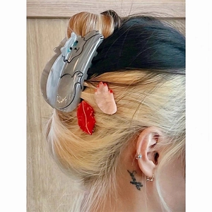 Cute acetate cat hair claw clip and small decorative side clips worn by a model