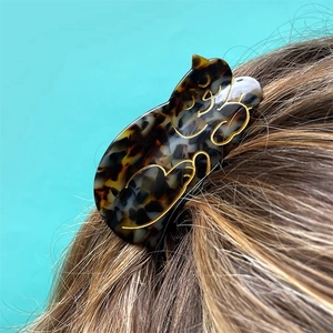 Cute acetate cat hair claw clip in tortoiseshell pattern with gold outlines on hair