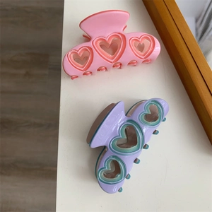 Pinces à cheveux rose et violette avec découpes en cœur pour coiffure élégante