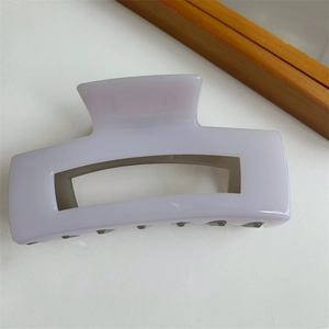 Detail view of a lavender purple square hair claw clip with a glossy hollowed out structure