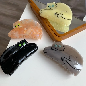 Set of four tortoiseshell acetate cat-shaped hair claws in assorted marble colors