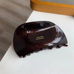 Close-up of tortoise shell hair claw with golden Barrette La France logo engraving