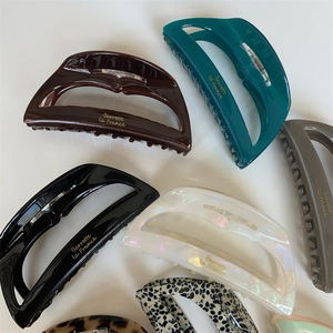 Detail of colorful acetate large hair claw clips with Barrette la France golden lettering