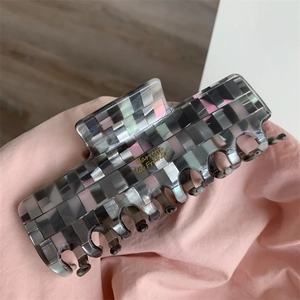 Détail de la pince à cheveux à carreaux avec lettrage doré Barrette la France