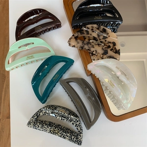 Detailed collection of acetate shark hair clips in tortoiseshell and solid colors