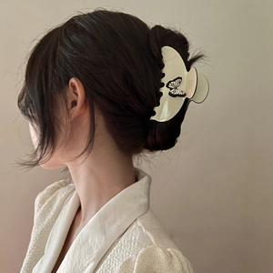 French vintage cream butterfly hair claw clip shown on hairstyle for elegant look