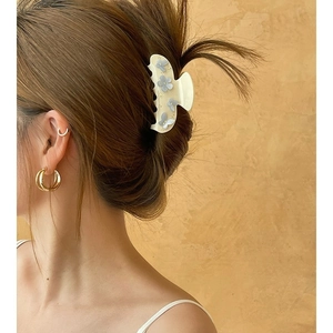 Elegante fermaglio per capelli a fiori e polsini dorati indossati lateralmente
