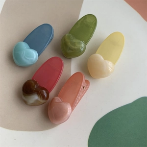 Set of 5 colorful jelly heart hair clips in pastel marble finish on a vibrant background
