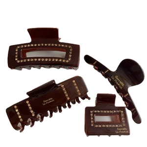 Brown hair claw set with gold rhinestones and Barrette la France brand lettering