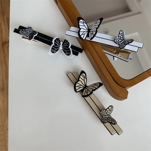 Close-up of vintage butterfly hair clips in black, white and brown acetate finish
