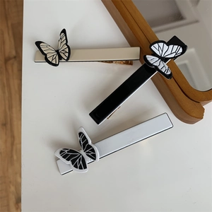 Three elegant French vintage butterfly hair clips in cream, black, and white colors