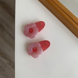 Close-up of pink marble resin flower hair clips set with smooth translucent finish