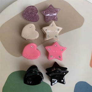Close-up of heart and star resin hair clips with rhinestones in various colors