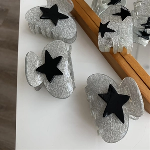 Sparkly silver hair claw clip with black star ornament and high-quality acrylic teeth