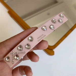 Close-up of pink heart rhinestone hairpin with France Handmade engraved detail