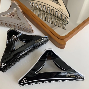 Geometric triangular hair claw clips with marble pattern and rhinestone accents