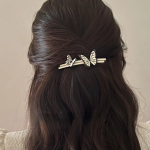 French vintage butterfly hair clip with black and white texture on elegant wavy hair