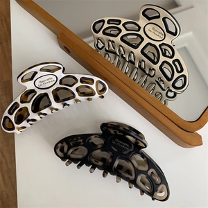 Three elegant resin hair claws with tortoise patterns and Barrette La France lettering