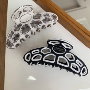 Chic marbled and black curved hair claws with Barrette La France gold lettering for women