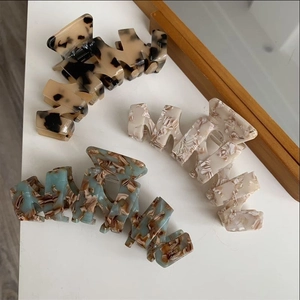 Detailed view of large acetate hair claws with tortoiseshell and marble patterns