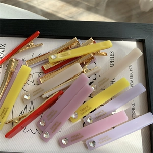 Colorful matte resin rectangular hair clips with heart diamond and gold lettering detail